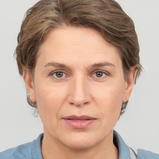 Joyful white adult female with short  brown hair and grey eyes