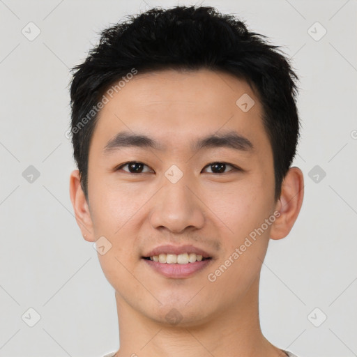 Joyful asian young-adult male with short  black hair and brown eyes