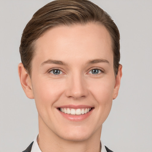 Joyful white young-adult female with short  brown hair and grey eyes