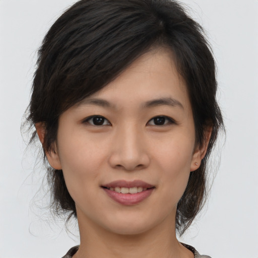 Joyful asian young-adult female with medium  brown hair and brown eyes