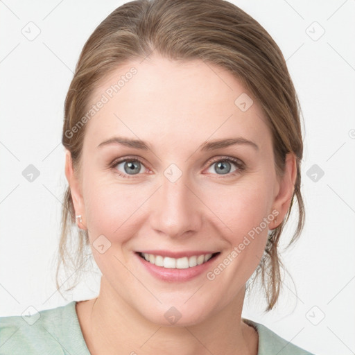 Joyful white young-adult female with medium  brown hair and blue eyes