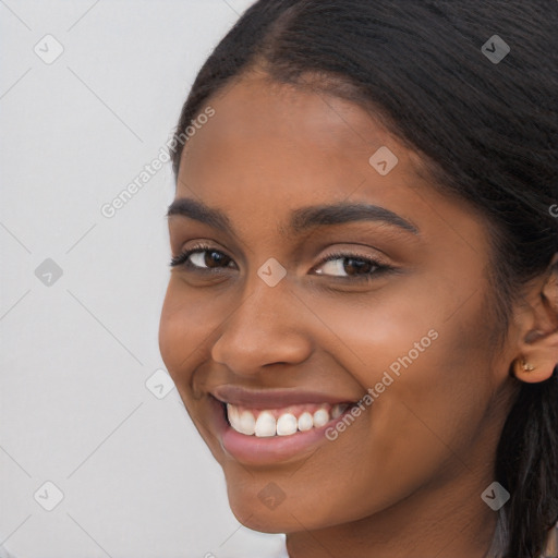 Joyful latino young-adult female with long  brown hair and brown eyes