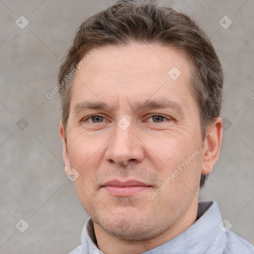 Joyful white adult male with short  brown hair and grey eyes