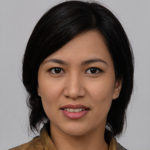Joyful latino young-adult female with medium  black hair and brown eyes
