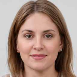 Joyful white young-adult female with long  brown hair and grey eyes