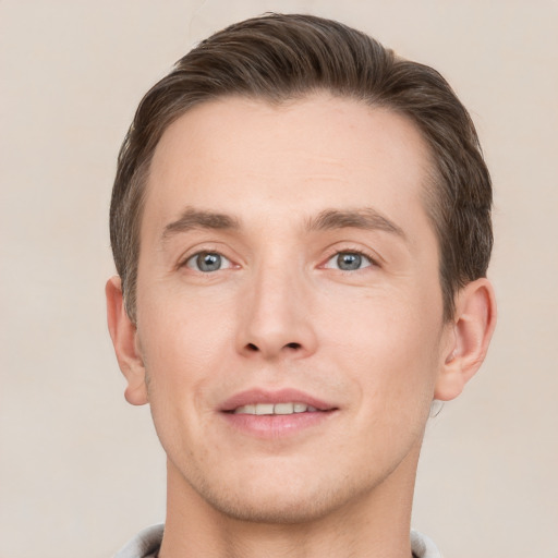 Joyful white young-adult male with short  brown hair and grey eyes