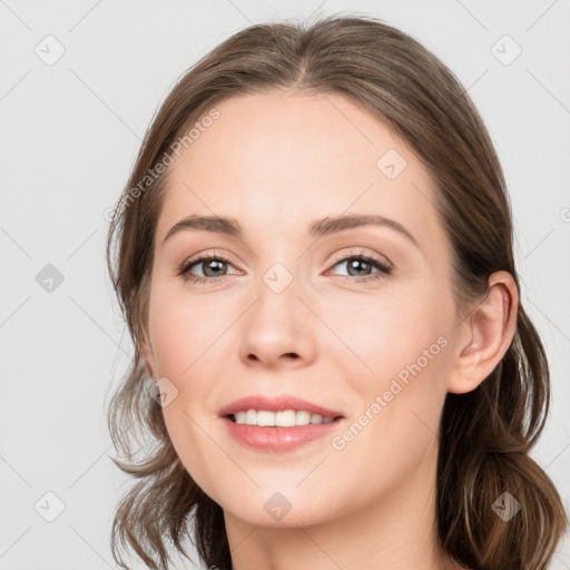 Joyful white young-adult female with long  brown hair and blue eyes