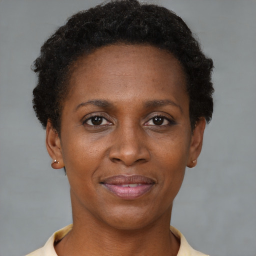 Joyful black adult female with short  brown hair and brown eyes