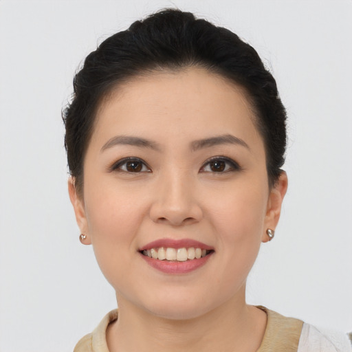 Joyful asian young-adult female with short  brown hair and brown eyes
