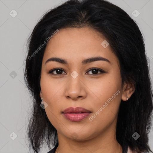 Joyful latino young-adult female with long  brown hair and brown eyes