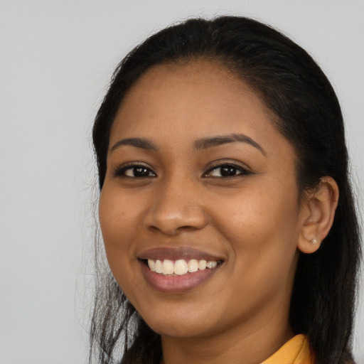 Joyful latino young-adult female with long  brown hair and brown eyes