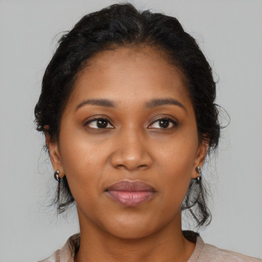 Joyful black young-adult female with medium  brown hair and brown eyes