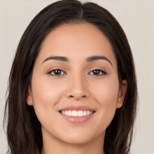 Joyful white young-adult female with long  brown hair and brown eyes