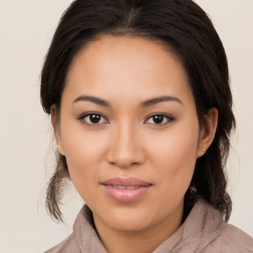 Joyful latino young-adult female with medium  brown hair and brown eyes