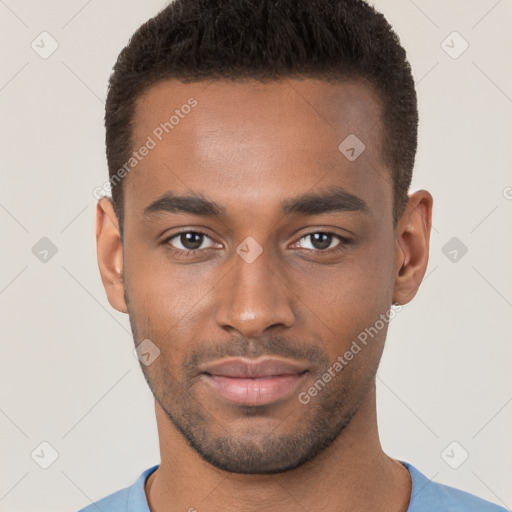 Joyful black young-adult male with short  brown hair and brown eyes