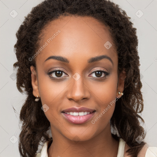 Joyful black young-adult female with long  brown hair and brown eyes