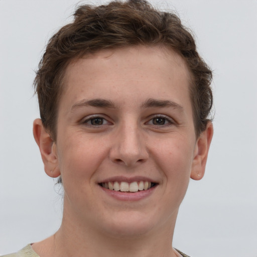 Joyful white young-adult female with short  brown hair and grey eyes