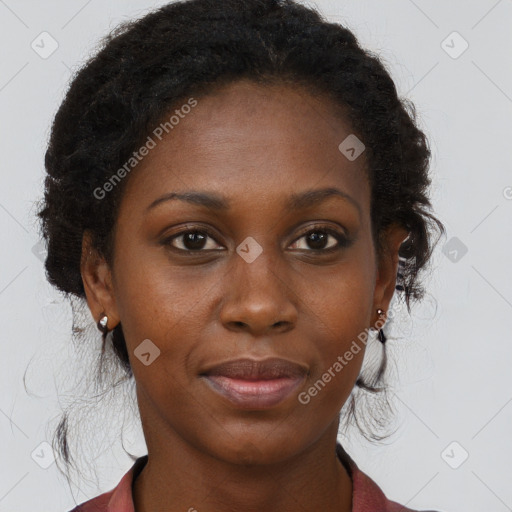 Joyful black young-adult female with long  brown hair and brown eyes