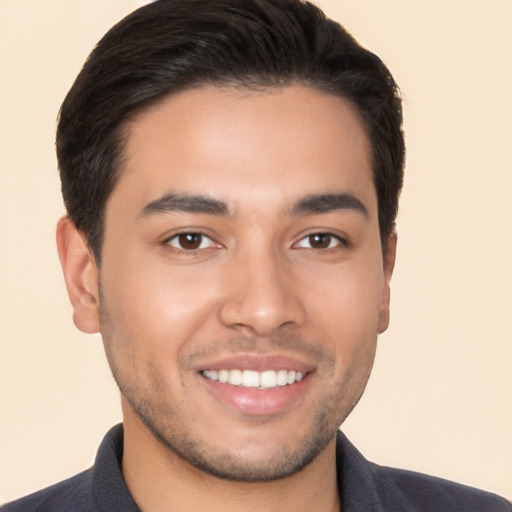 Joyful white young-adult male with short  black hair and brown eyes