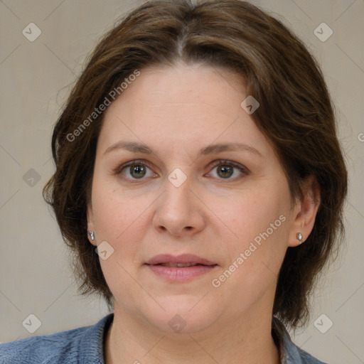 Joyful white adult female with medium  brown hair and grey eyes