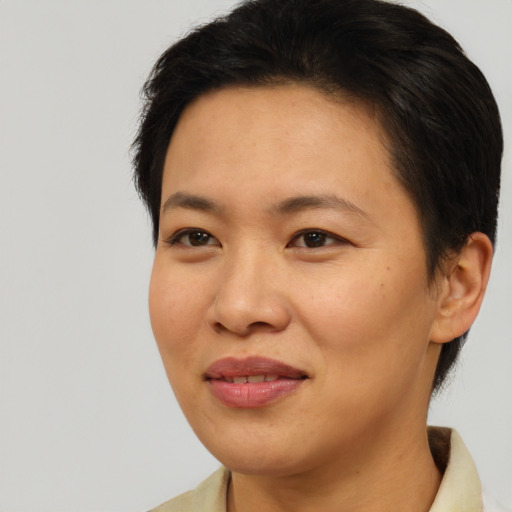 Joyful asian young-adult female with short  brown hair and brown eyes