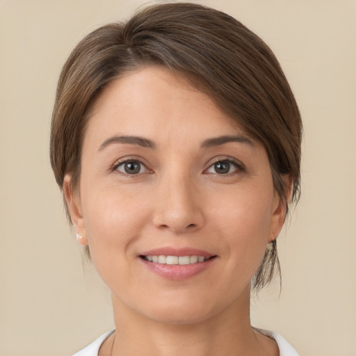 Joyful white young-adult female with short  brown hair and brown eyes