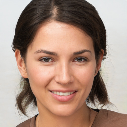 Joyful white young-adult female with medium  brown hair and brown eyes