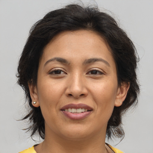 Joyful asian adult female with medium  brown hair and brown eyes