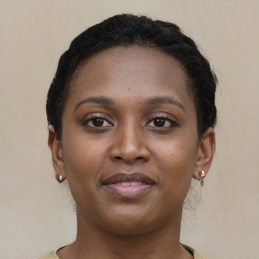 Joyful black young-adult female with short  brown hair and brown eyes