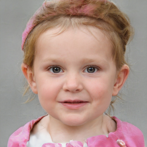 Joyful white child female with short  brown hair and blue eyes