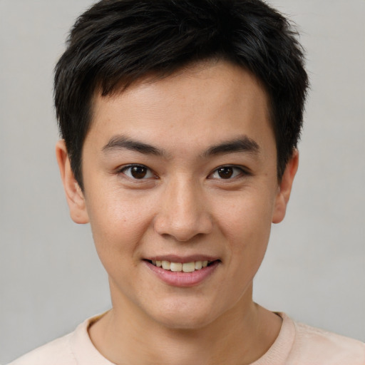 Joyful asian young-adult male with short  brown hair and brown eyes