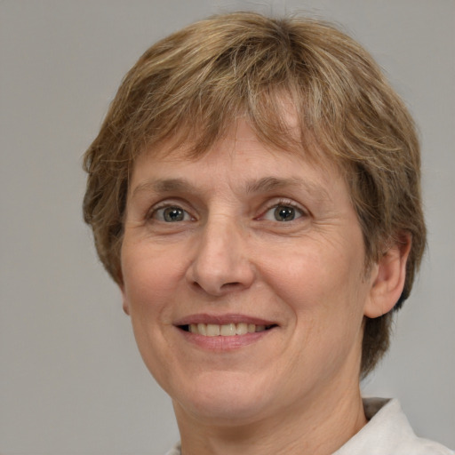 Joyful white adult female with medium  brown hair and green eyes