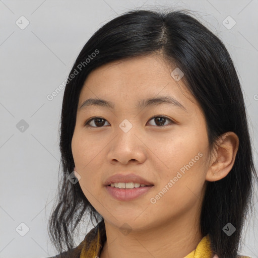 Joyful asian young-adult female with medium  black hair and brown eyes