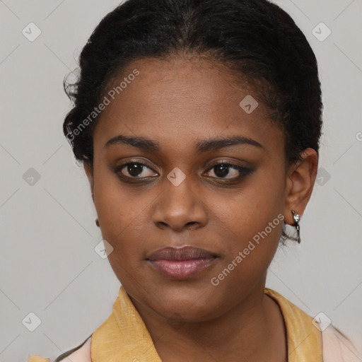 Joyful black young-adult female with short  brown hair and brown eyes