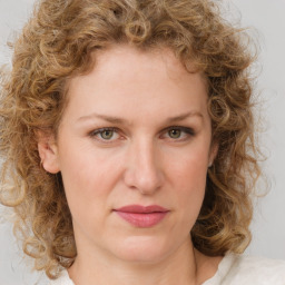 Joyful white young-adult female with medium  brown hair and green eyes