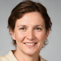 Joyful white adult female with medium  brown hair and grey eyes