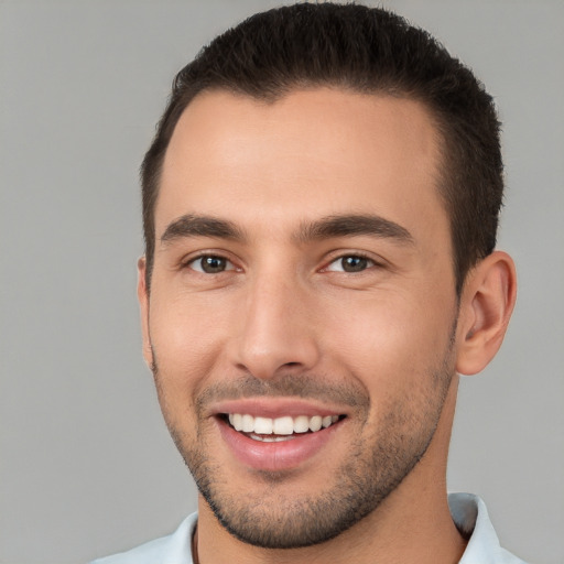 Joyful white young-adult male with short  brown hair and brown eyes