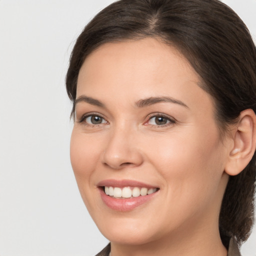 Joyful white young-adult female with medium  brown hair and brown eyes