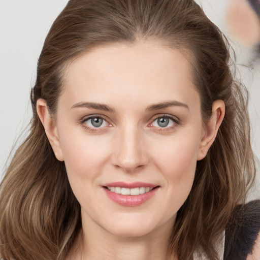 Joyful white young-adult female with long  brown hair and grey eyes