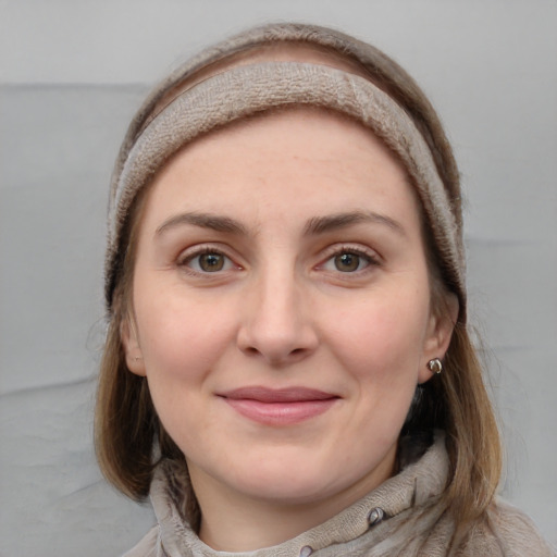 Joyful white young-adult female with long  brown hair and grey eyes