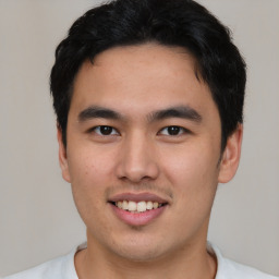 Joyful asian young-adult male with short  black hair and brown eyes