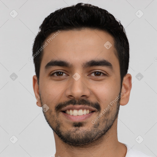 Joyful latino young-adult male with short  black hair and brown eyes