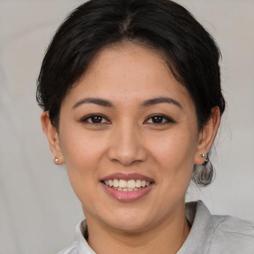 Joyful white young-adult female with medium  brown hair and brown eyes