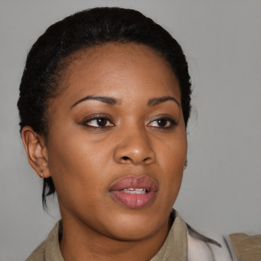 Joyful black young-adult female with short  brown hair and brown eyes