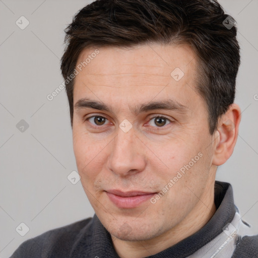 Joyful white adult male with short  brown hair and brown eyes