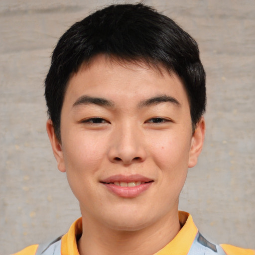 Joyful asian young-adult male with short  brown hair and brown eyes