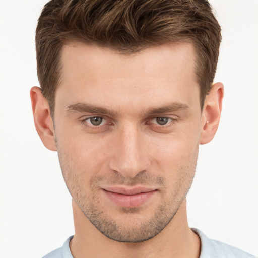 Joyful white young-adult male with short  brown hair and grey eyes