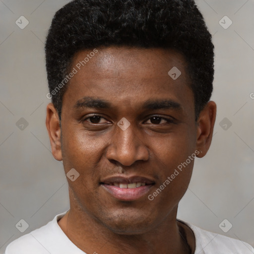 Joyful black young-adult male with short  black hair and brown eyes