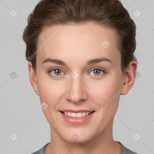 Joyful white young-adult female with short  brown hair and grey eyes