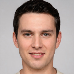 Joyful white young-adult male with short  brown hair and grey eyes